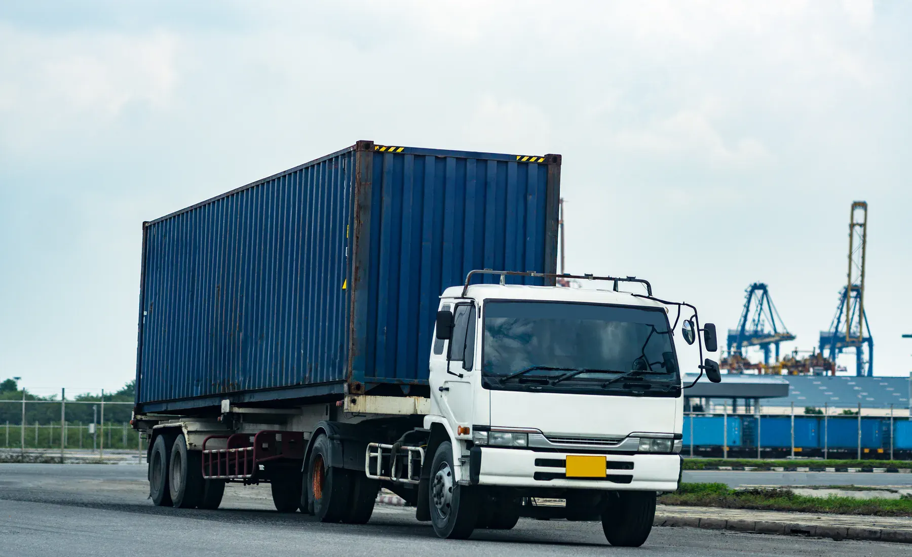 Cargo truck and container terminal representing coordinated shipment movement